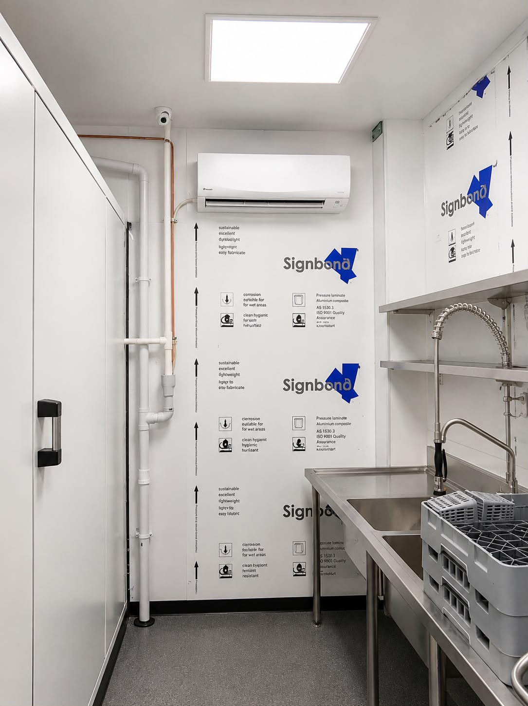 Commercial kitchen wash-up area with a cool room door and split system air conditioning